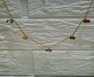 Necklace with colorful gemstones on a textured white background